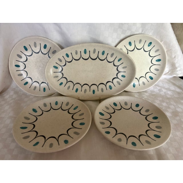 A set of 4 dessert or salad plates by Metlox in the Poppytrails pattern and a small oval serving dish.The serving dish is...