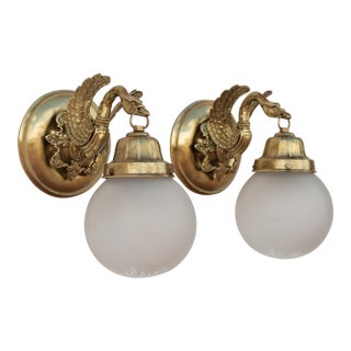 1950s Spanish Empire Chased Brass Swan Wall Sconces With Starburst Frosted Globes - A Pair For Sale