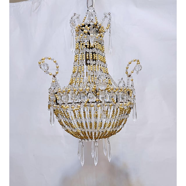 Empire style chandelier with clear plain beads and opaque color. It fully rewired. It has 1 candelabra socket that can...