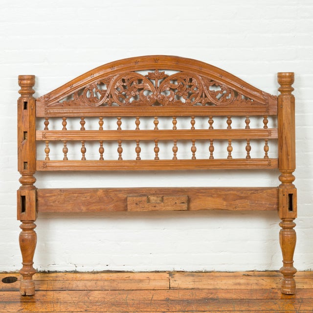 A carved vintage Indonesian headboard from the mid-20th century, with scrolling foliage and petite balusters. Crafted in...