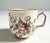 Antique small porcelain cup with handpainted flowers and a crest and crown.