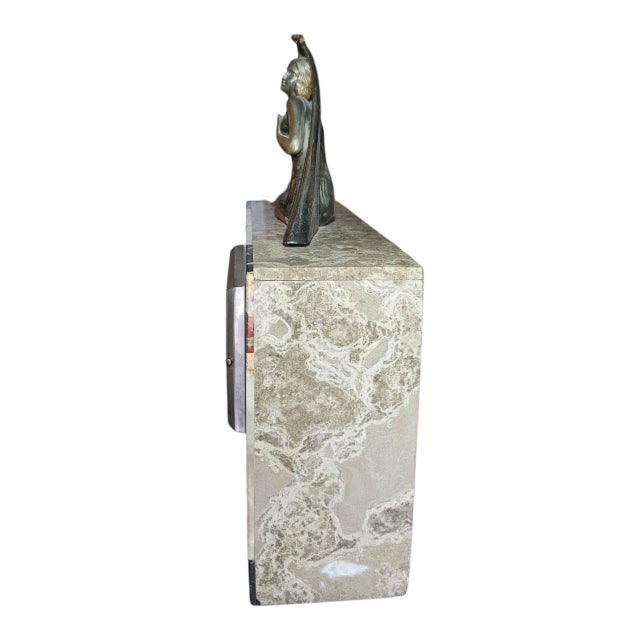 The elegant Art Deco French clock's case is composed of variegated marble in cream, black with gold veines, green , coral...