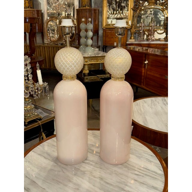 This product is a pair of modern Murano glass lamps featuring a beautiful combination of pale pink and gold colors. The...