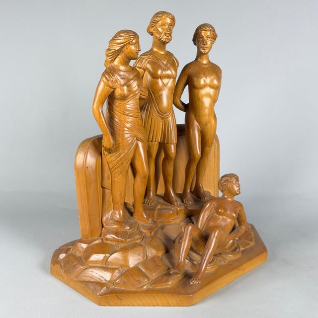 An important and rare large-scale sculpture made of carved solid wood. This figurative group, signed at the base, is...