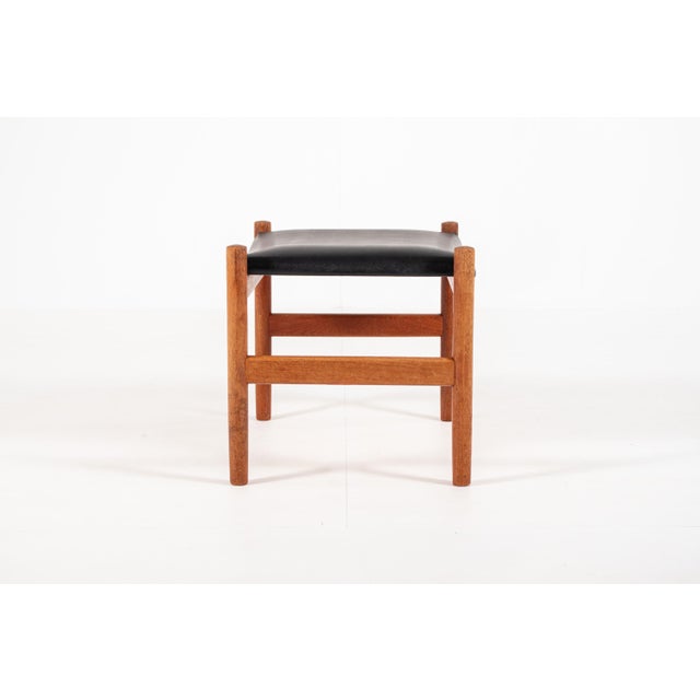 A beautifully crafted Danish teak ottoman designed by Hugo Frandsen for Spøttrup Møbelfabrik, Denmark, circa 1960s. This...