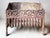 Cast iron log holder/fireplace basket Height 31 cm Width 38 cm Depth 21 cm Note a break on the right and a crack on the...