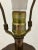 This signed Frederick Cooper lamp is solid brass with a bronze patina. The cap and base are solid wood. The form is styled...