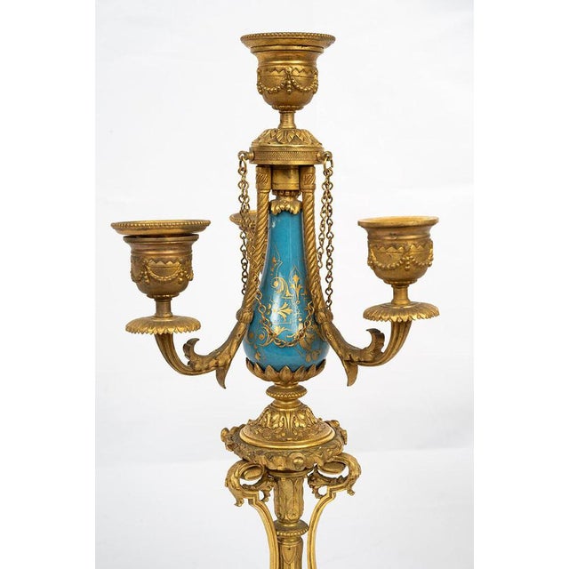 A pair of antique candlesticks in finely chiselled gilded bronze with inlays of Sèvres porcelain, dating from the second...