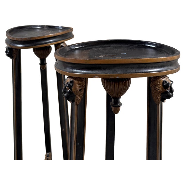 A pair of tall Neoclassical, French Empire style torchère pedestals, each raised on three tapering, reeded legs joined by...