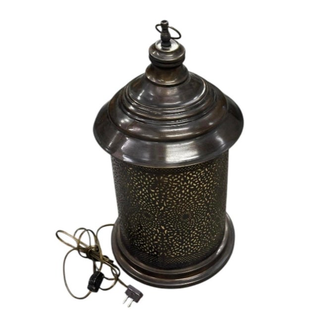 Elevate your living space with the warm, atmospheric glow of this vintage Moroccan-style table lantern lamp. Crafted with...