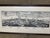 Vintage-style panoramic print of Siena, Italy is set in a dark wood frame with a white mat. The artwork is a black and...