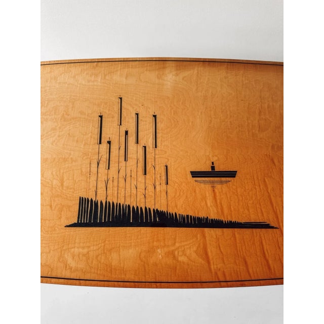 A refined mid-century coffee table featuring a beautifully patterned wooden top that brings warmth and character to any...