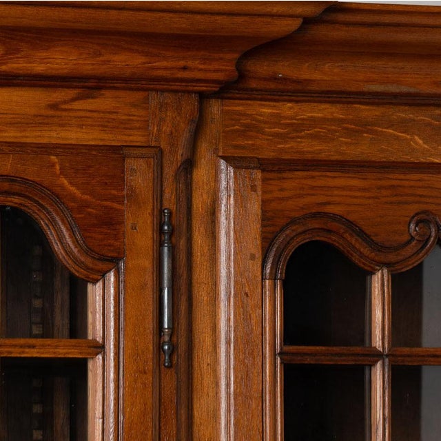 Large 20th century French bookcase display cabinet, crafted in oak with a warm natural patina. The upper section has four...