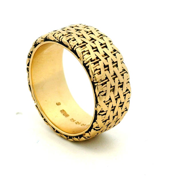 A substantial vintage cigar band crafted in 14K yellow gold, distinguished by an intricate basket-weave motif extending...