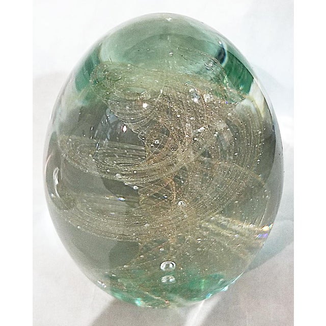 Fun and elegant egg shaped paperweight, Italian via Neimman-Marcus, aqua blue swirled gold with trapped bubbles.