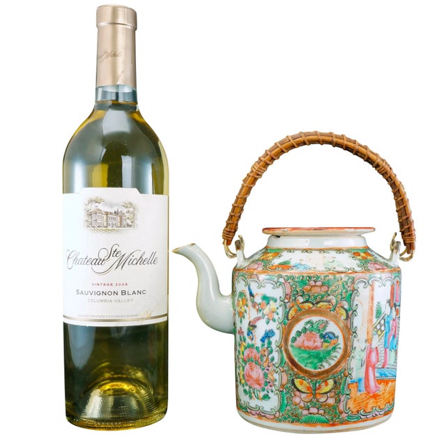 A generously-sized porcelain Chinese teapot with colorful rose medallion painting. The molded teapot has matching round...