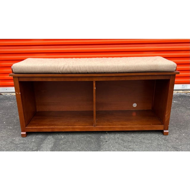 This wood bench has an open bottom to store shoes and a nice padded seat to sit down to take your shoes off when you come...