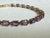 Vintage 1980s 10K yellow gold tennis bracelet featuring a continuous row of 22 oval-cut purple amethysts in rich medium to...