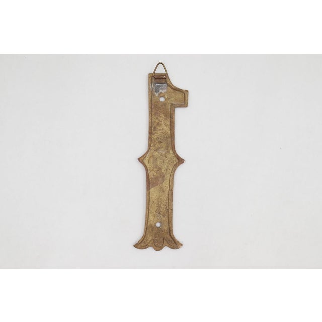 Solid polished brass number 1 with two predrilled screw holes and a triangular hanging hook. The original mounting screws...