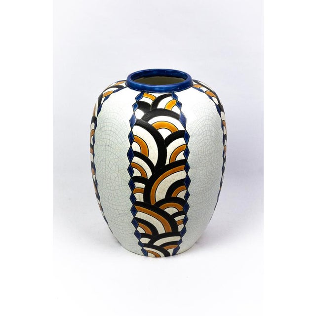 Fine-paste earthenware enriched with siliceous frit, covered with a high-fire crackle glaze; polychrome decoration in...