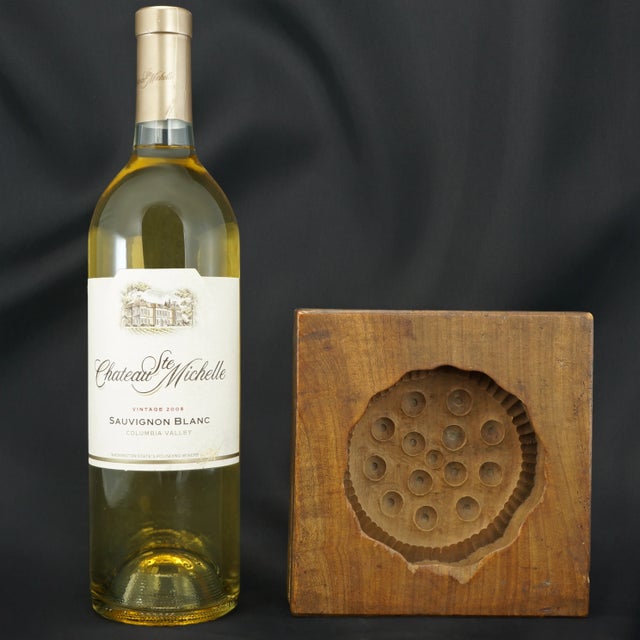 A hand carved hardwood bean paste mold that was carved to look like a lotus seed pod. The lotus seed pod was a symbol for...