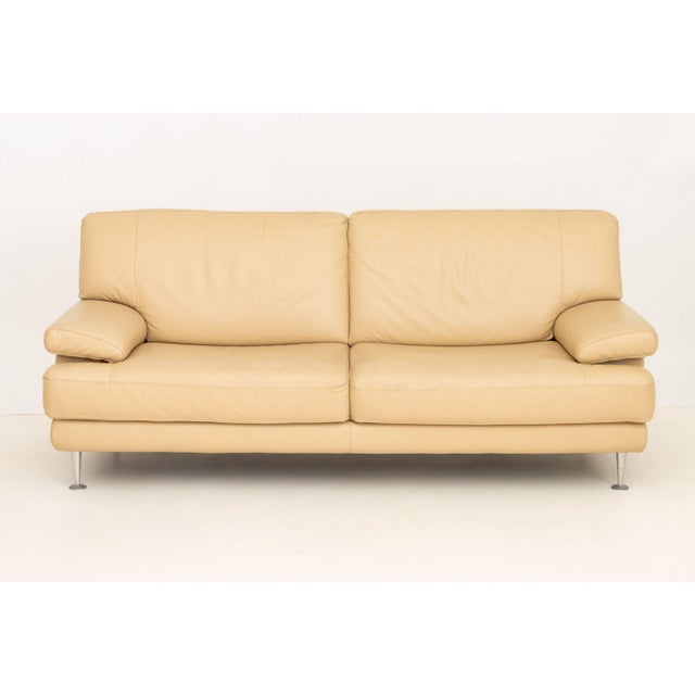 Nicoletti Beige Leather Upholstered Two-Seat Sofa, with labels to side and underside. 33" H x 78" W x 37" D; seat: 11" H....