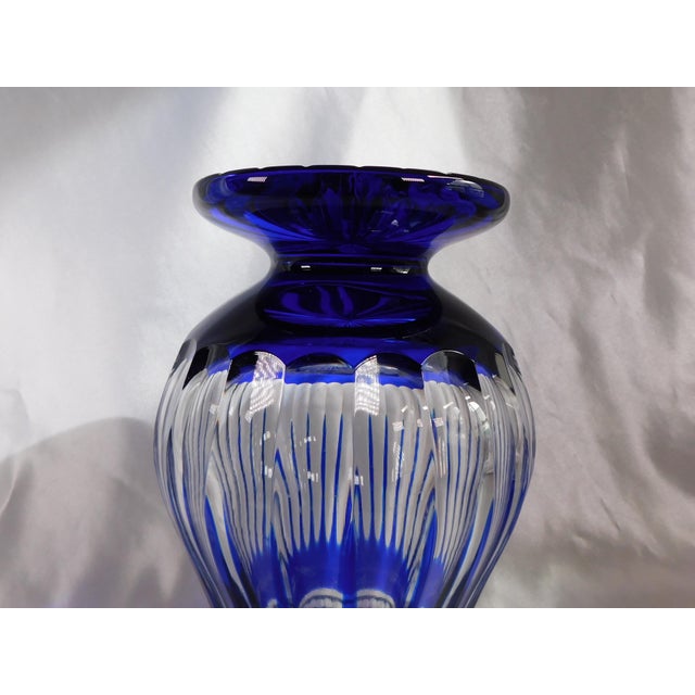 This is a large blue cut to clear vase. The blue glass is thick and solid and the cuts are sharp but there is a spot shown...