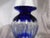 This is a large blue cut to clear vase. The blue glass is thick and solid and the cuts are sharp but there is a spot shown...