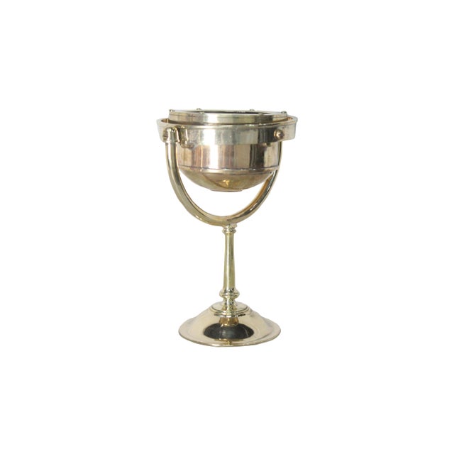 A ship's brass English compass from a decommissioned lifeboat. This is made by Cassens and Plath, an English company. An...