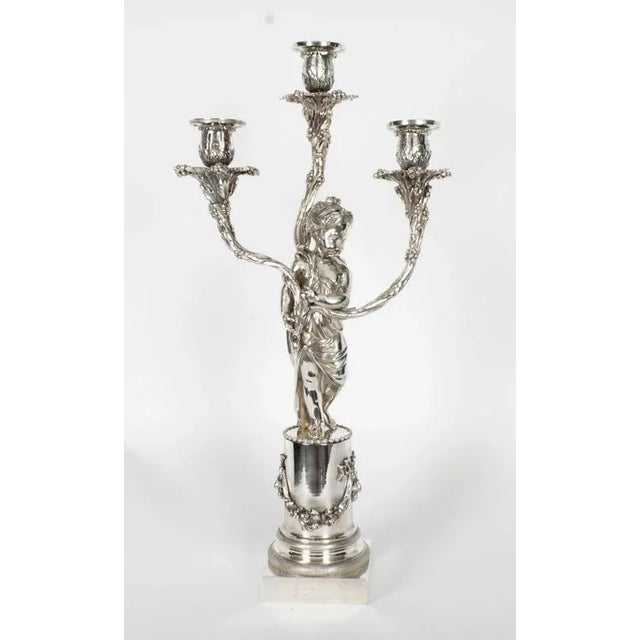 This is an elegant pair of antique English silver plated three light table candelabra, in the manner of Elkington, circa...
