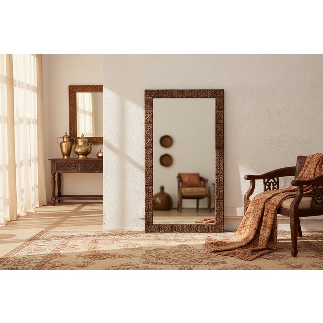 A striking example of architectural salvage repurposed as a grand mirror. The wide frame is clad in antique pressed tin...