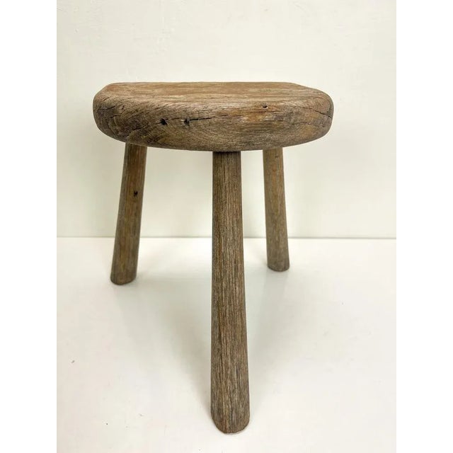 A beautifully lived old tripod oak stool, the color is light brown to weathered grey. The stool really tells a story and...