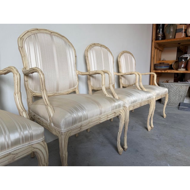 Elegant set of four vintage arm dining chairs manufactured by Century Furniture in the iconic style of Serge Roche,...