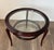 This beautiful round coffee table is made of walnut with two glass tops. It is an Italian work by the famous designer...