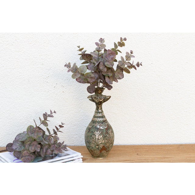 A captivating piece, this bronze vase features intricate archaistic patterns and distinctive silver, brown, and verdigris...