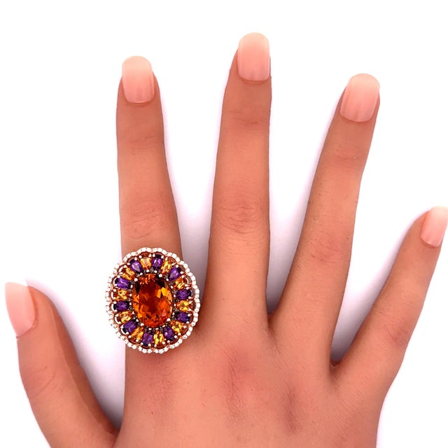 An exquisite oval-cut citrine, takes center stage in this contemporary fashion ring. The citrine boasts a vibrant orange...