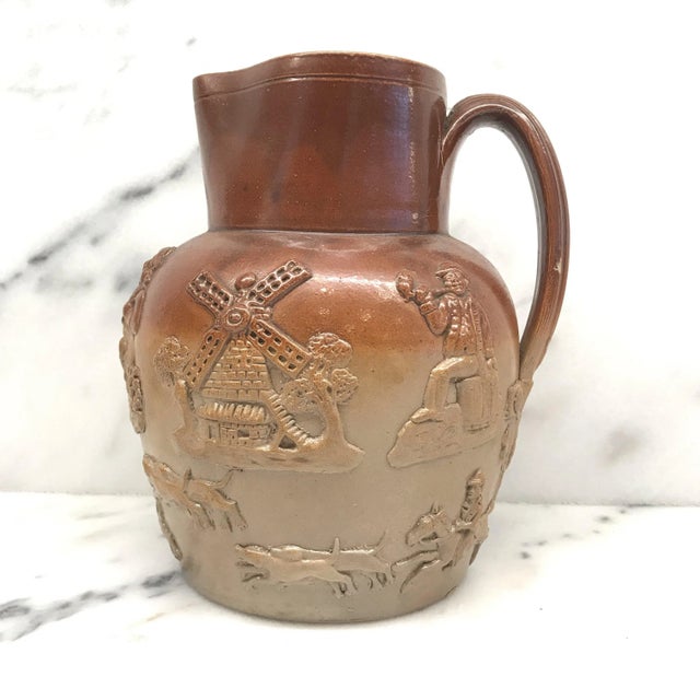 This is a good stoneware jug or pitcher made by The Royal Doulton, Lambeth, London factory, very early in the 20th...