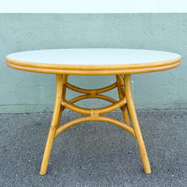 A fresh take on classic coastal design, this vintage boho chic dining table pairs a crisp white laminate top with a warm...