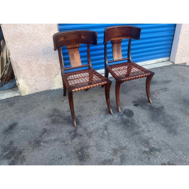 Klismos modern walnut chairs. Chairs are made of solid walnut and have a natural walnut finish. Chairs are in beautiful...