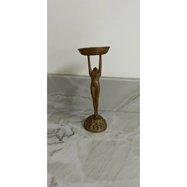 Unique Art Deco Frankart style figural metal ashtray stand featuring a nude women holding up the ashtray stand standing on...