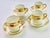 An exquisite elegant set of four antique demitasse coffee cans and matching saucers, crafted in fine porcelain with...
