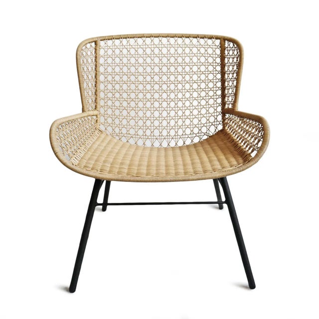 Outdoor woven neutral sand toned poly rope wicker easy chair. Matte black powder coated iron legs. Seat height is ~ 18".