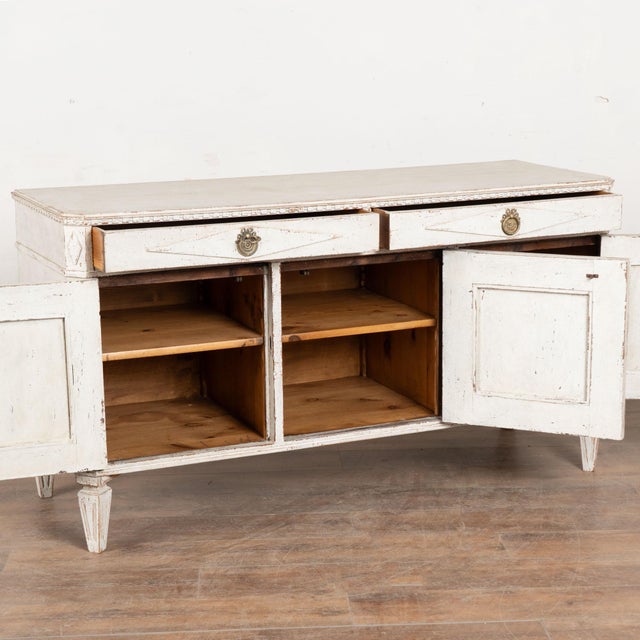 19th century Swedish sideboard, crafted in pine. The piece features two drawers over three door configuration and has been...