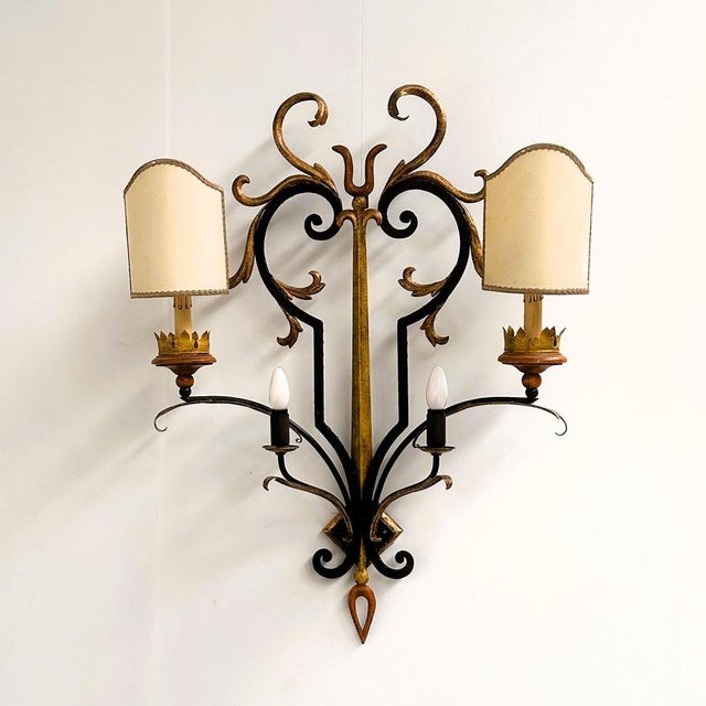 A spectacular and highly decorative vintage italian florentine wrought iron and toleware wall sconce, dating from circa...