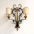 A spectacular and highly decorative vintage italian florentine wrought iron and toleware wall sconce, dating from circa...