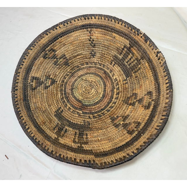 This antique hand-woven wicker figural Nigerian Hausa culture coiled basket is a unique and handmade piece that showcases...