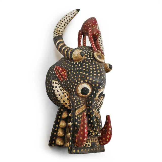 Original Fire Spitter Helmet mask from the Senufo people. Hand painted with powerful red, black and white polka dots makes...