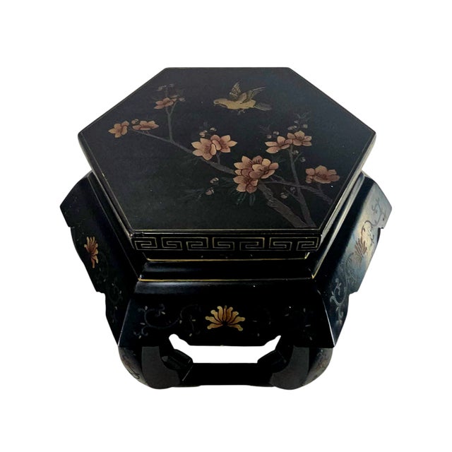 This mid-century Chinese lacquered hexagon table holds stories in its finely inlaid floral design, each petal and leaf...
