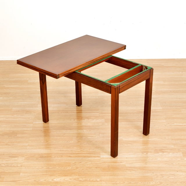 A fantastic vintage teak card table made in England during the 1950s. With a fold-out top, revealing a green felt playing...