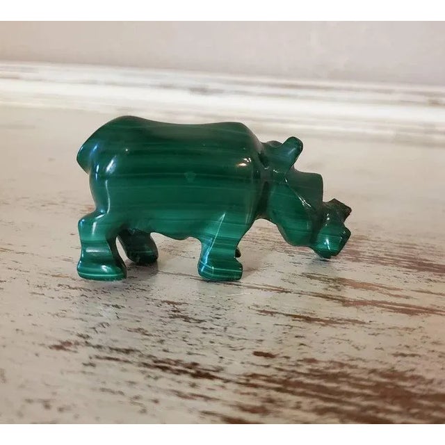 A beautiful, natural, solid, and substantial hand carved and polished bright green malachite stone in the shape of a...